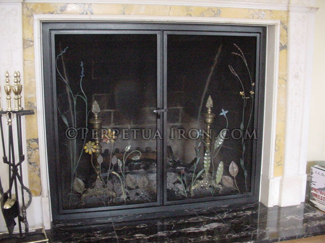 Wrought Iron Fireplace screen or fire screen rectangular frame with grass and flower motif custom fit to a marble and onyx fireplace.