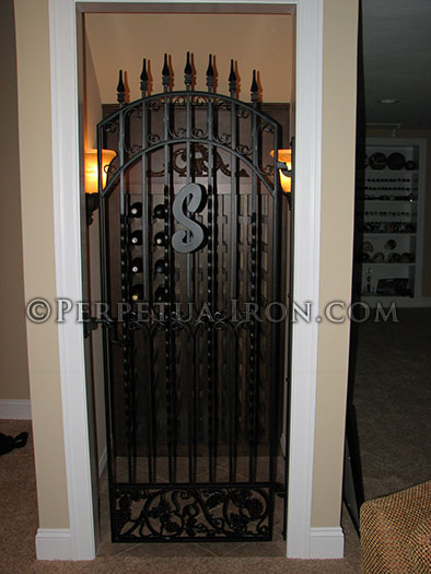 Wine cellar iron gate, handmade design components with cast iron patterns.