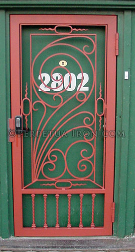 Green door and frame with the number 2802 in white is secured with an art nouveau inspired, broadly scrolled gate. This custom security gate is designed to make your front door more attractive instead of the standard ugly door gate.