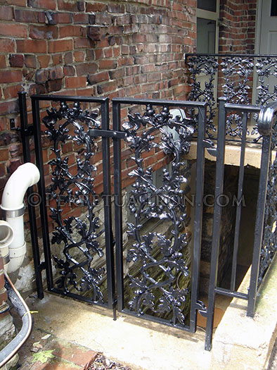Custom iron gate with oak leaf cast iron patterns.
