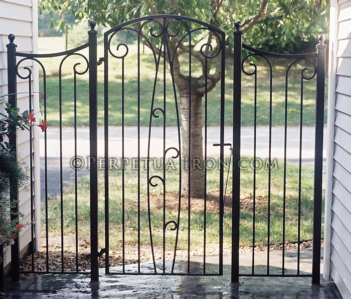 Custom iron gate for a patio with scroll designs.