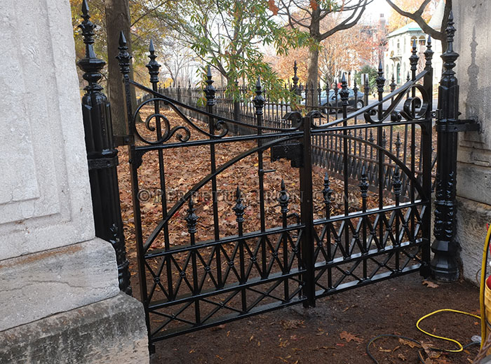 reproduction of old iron gates for a Victorian park. The gates are stationed between two heavy, ornate limetone collumns.