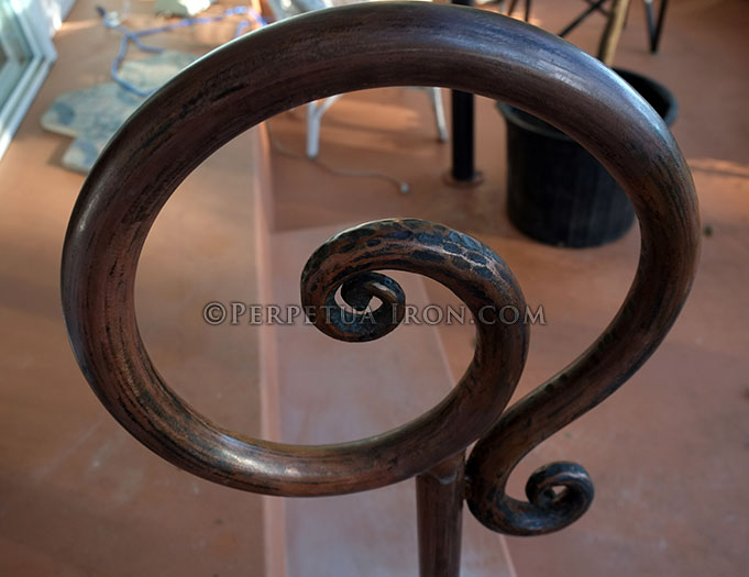 Side view detail of a Custom made curved and scrolled single post handrail.